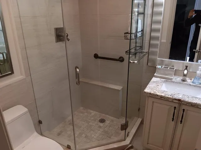 a bathroom with a granite countertop shower a toilet and sink