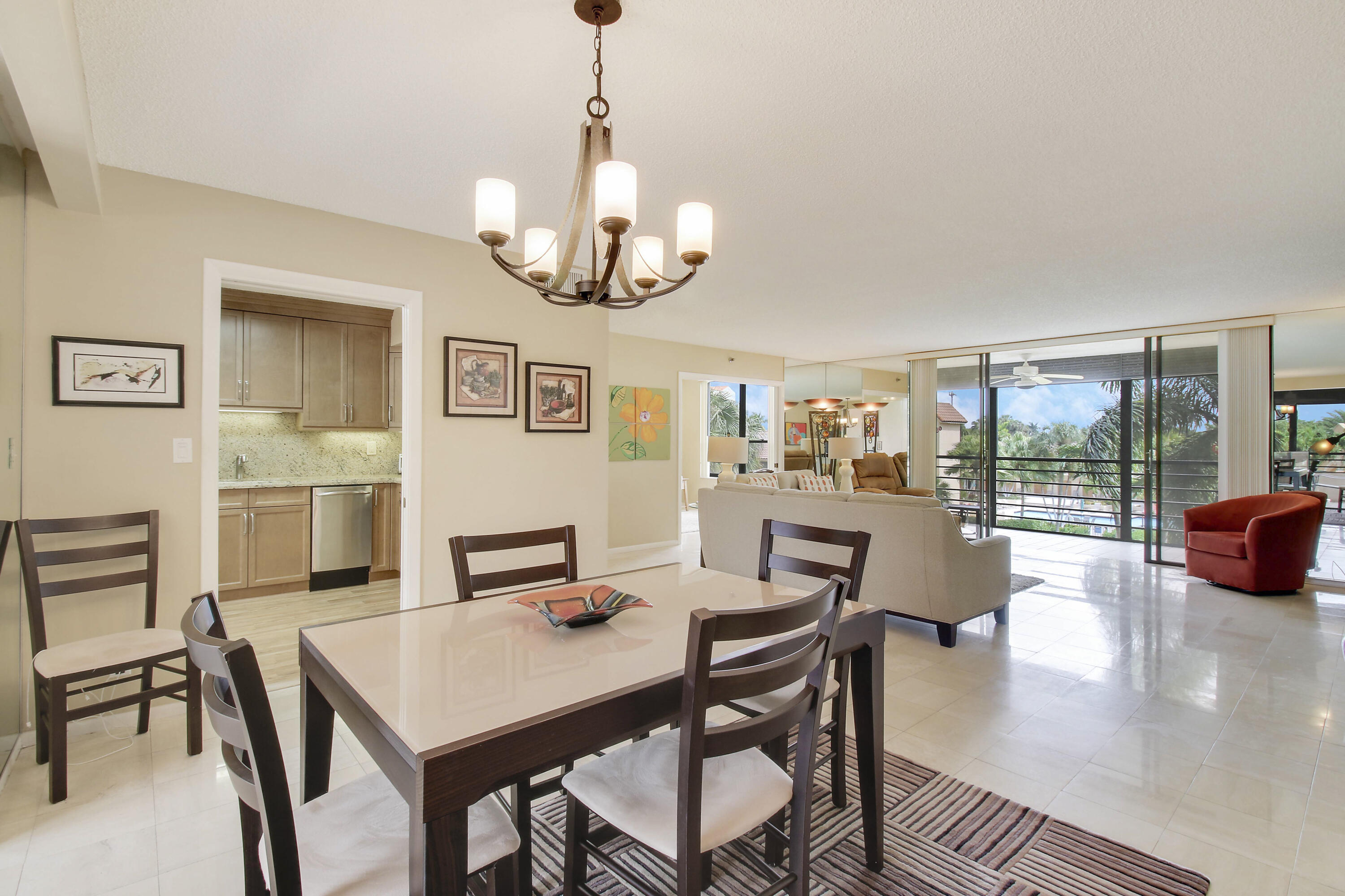 7201 Promenade Drive, Unit 301 Boca Raton, FL 33433 - Photo 15 of 40 a view of a dining room with furniture wooden floor and chandelier