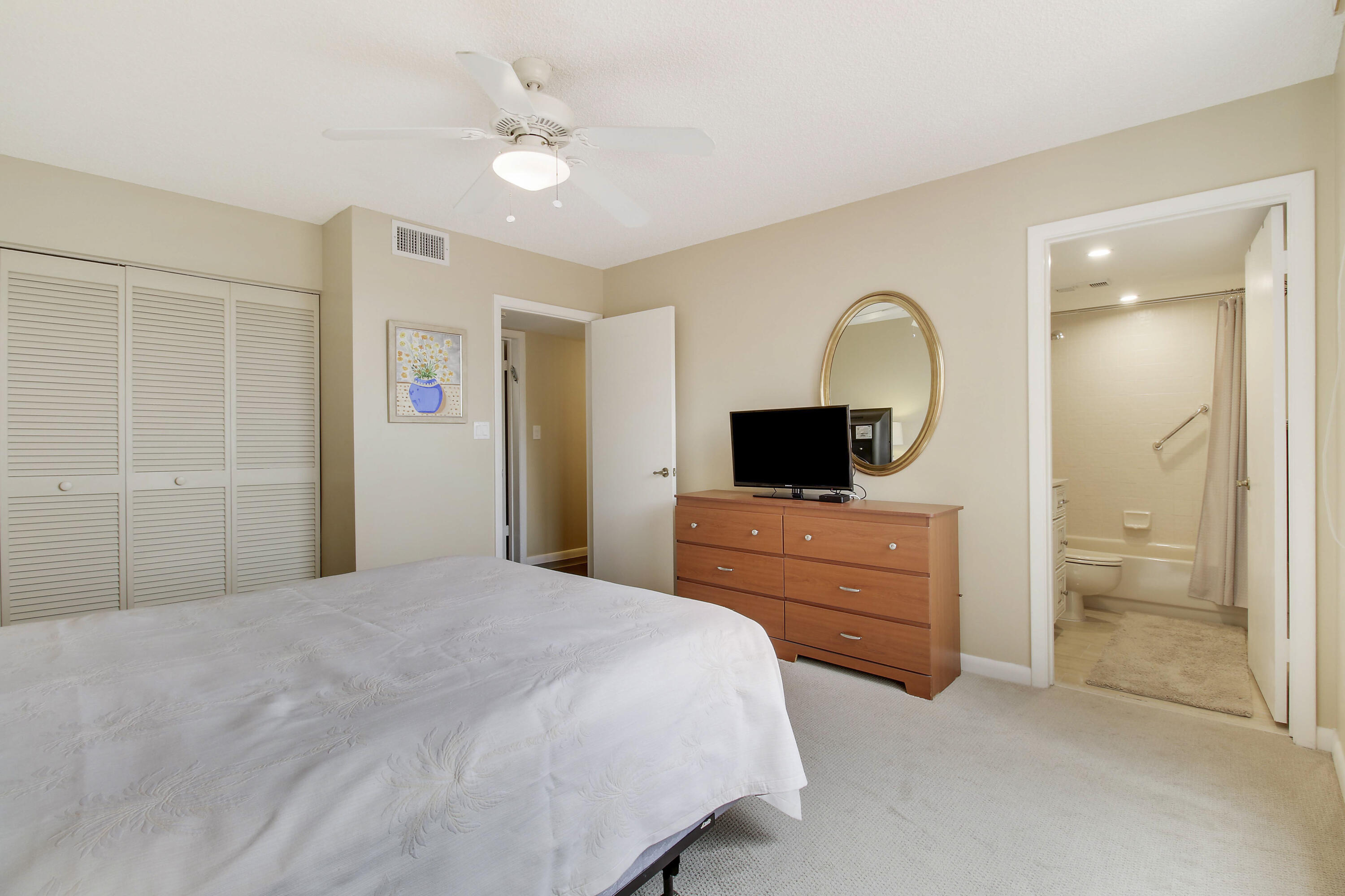 7201 Promenade Drive, Unit 301 Boca Raton, FL 33433 - Photo 24 of 40 a bedroom with a bed and a television