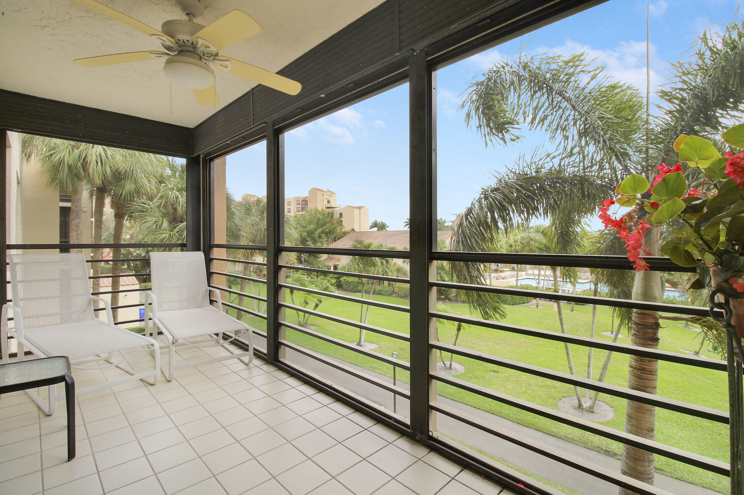 7201 Promenade Drive, Unit 301 Boca Raton, FL 33433 - Photo 28 of 40 a view of a porch with a floor to ceiling window and a table