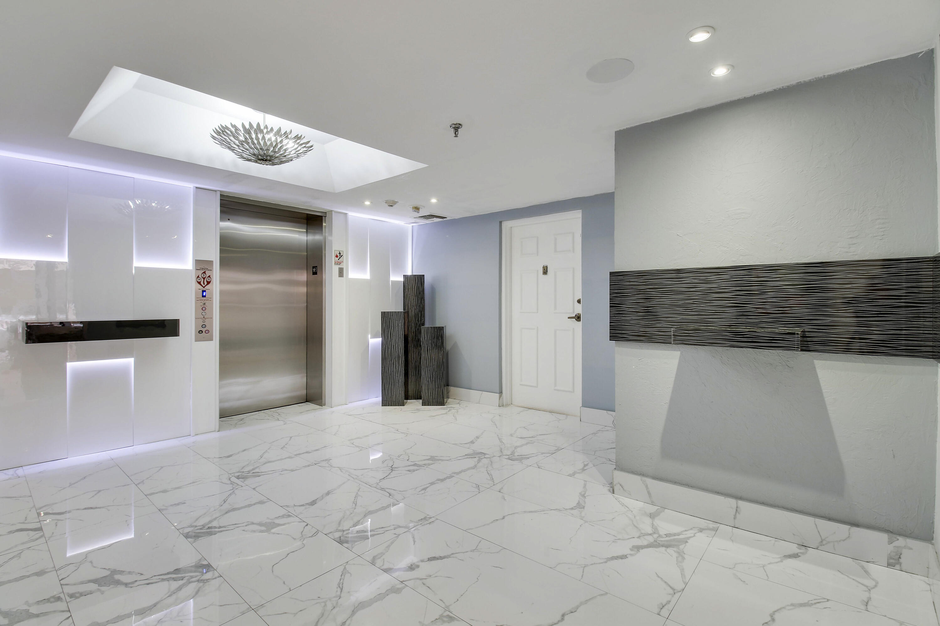 7201 Promenade Drive, Unit 301 Boca Raton, FL 33433 - Photo 3 of 40 a view of a refrigerator in kitchen and an empty room