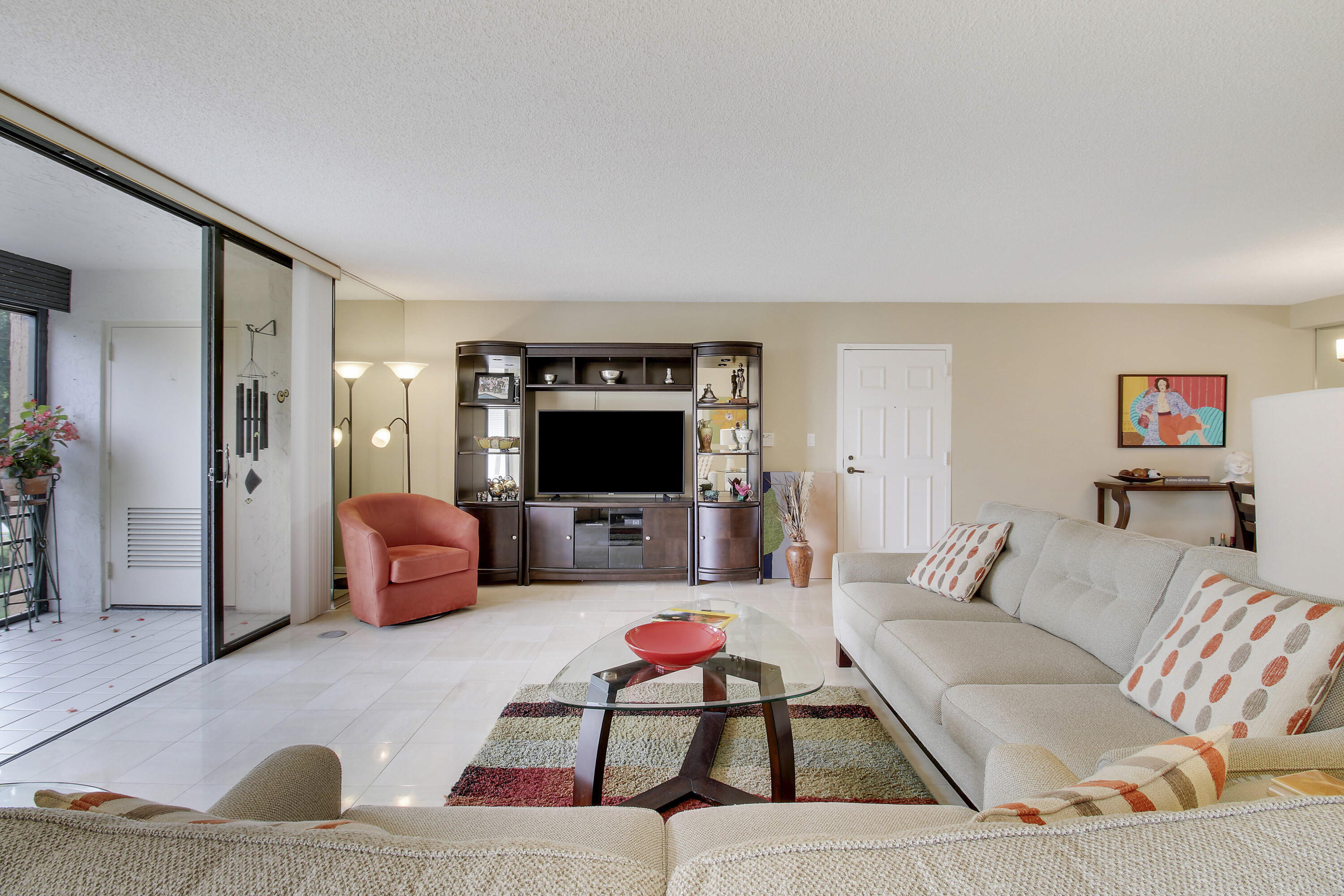 7201 Promenade Drive, Unit 301 Boca Raton, FL 33433 - Photo 7 of 40 a living room with furniture and a flat screen tv