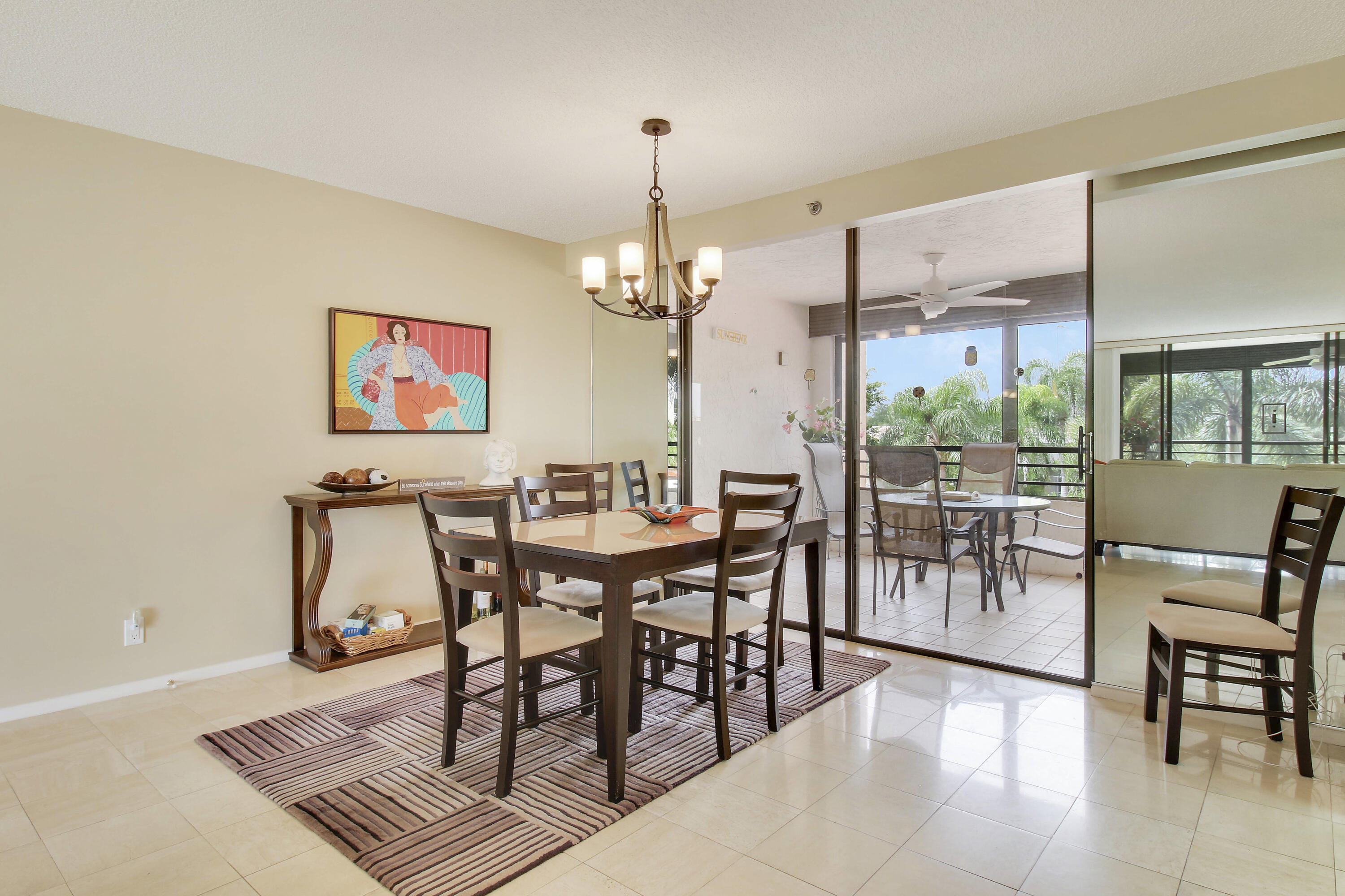 7201 Promenade Drive, Unit 301 Boca Raton, FL 33433 - Photo 9 of 40 a view of a dining room with furniture wooden floor and a chandelier