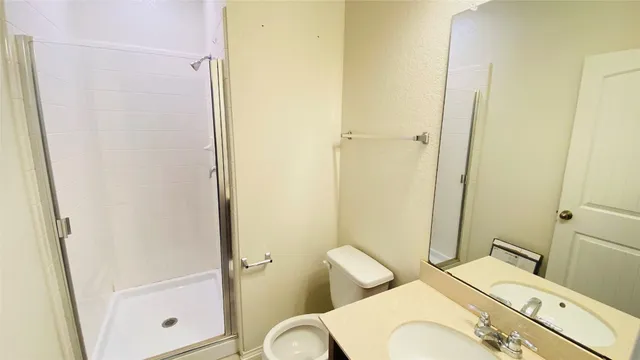 a white toilet sitting next to a bathroom sink