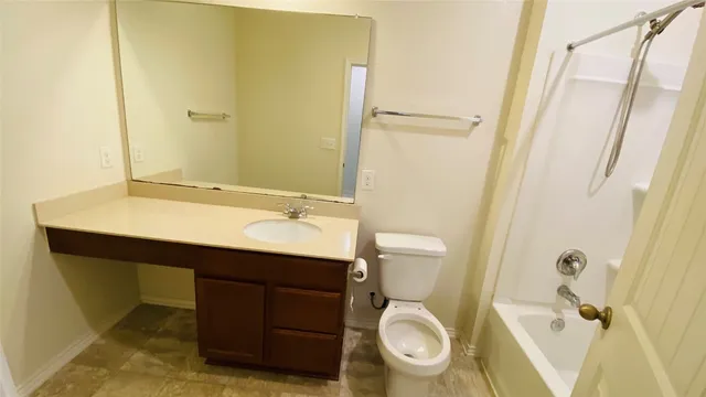 a bathroom with a sink a toilet a mirror and shower