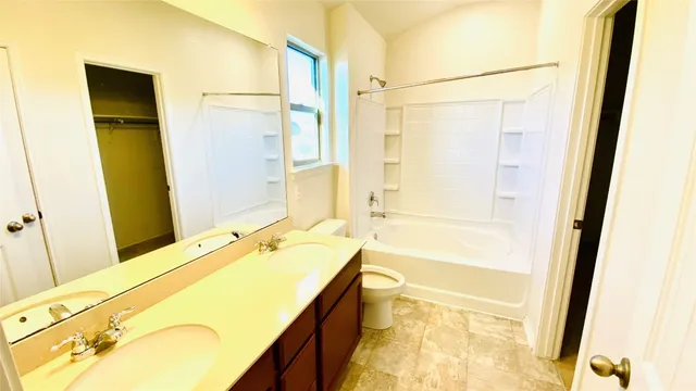 a bathroom with a tub sink and a mirror