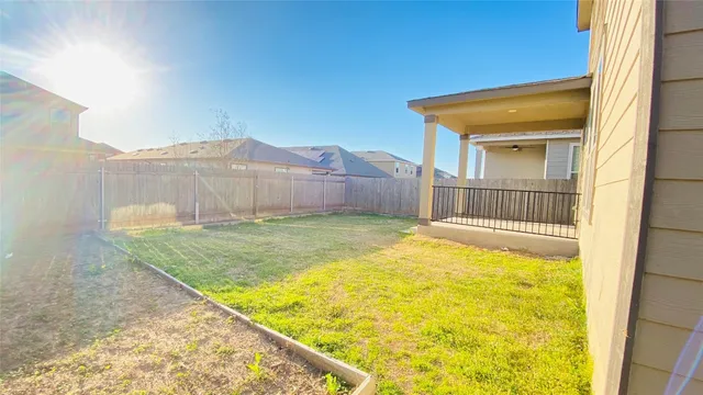 a view of an house with swimming pool and a yard