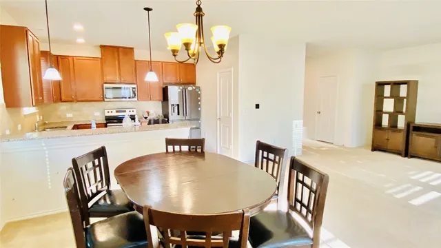 a dining room with furniture a window and kitchen view