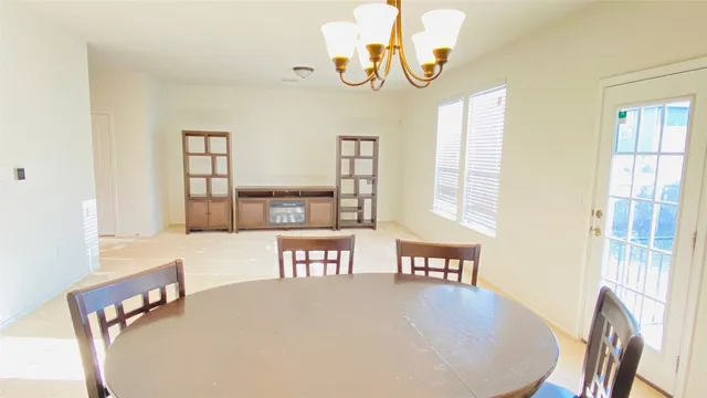 a dining room with furniture and window