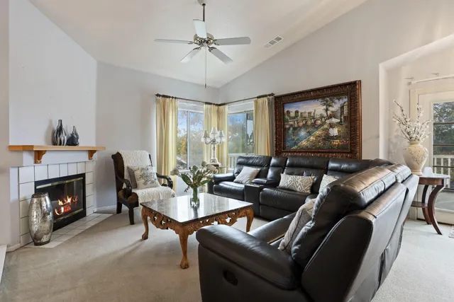 a living room with furniture and a fireplace