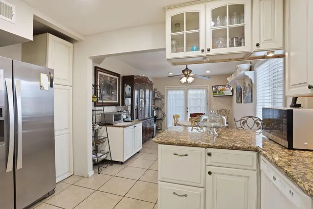 a kitchen with a refrigerator and a sink