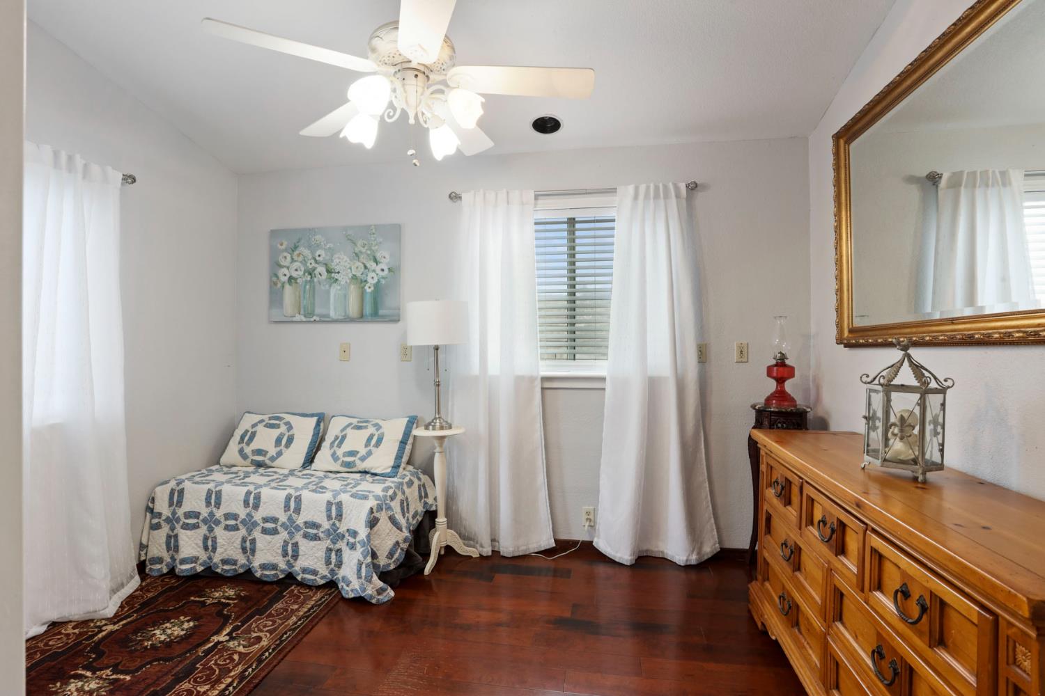 1601 Spring Court Tracy, CA 95376 - Photo 23 of 49 a bedroom with a bed and a chandelier