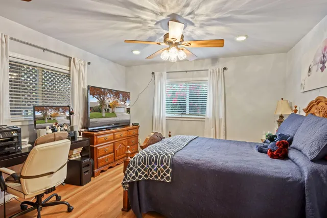 a bedroom with a bed and a chandelier