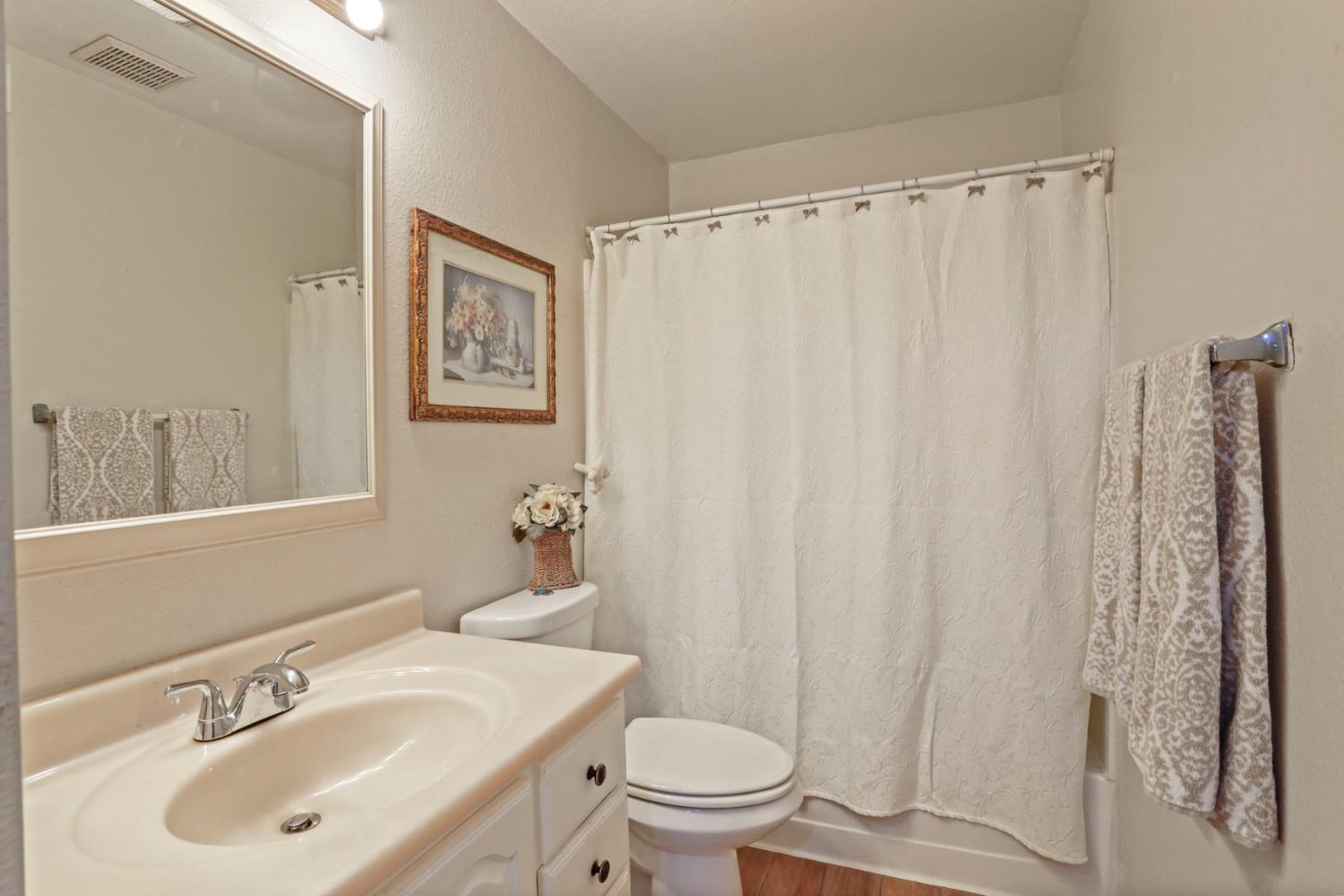 1601 Spring Court Tracy, CA 95376 - Photo 25 of 49 a bathroom with a sink toilet and shower