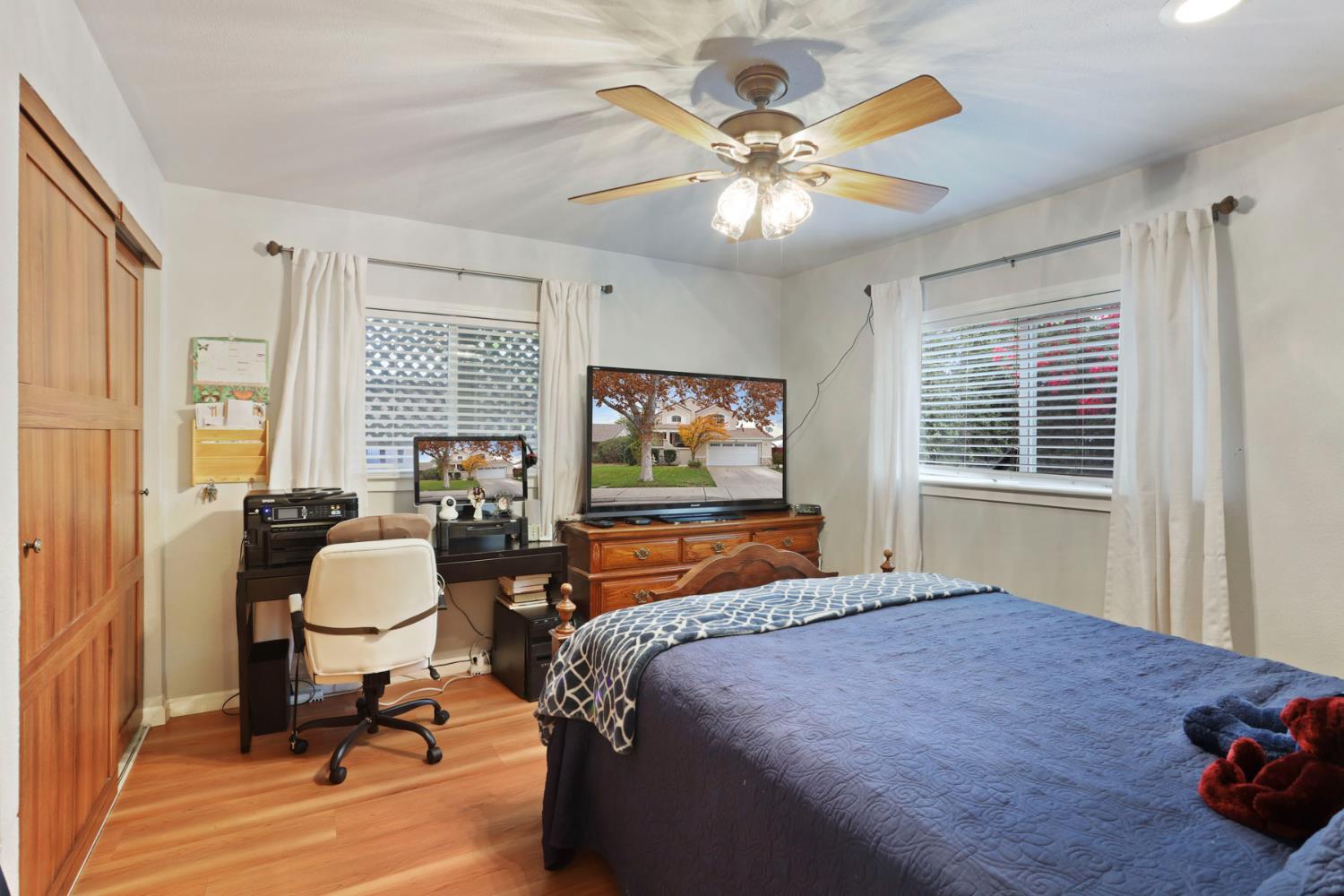 1601 Spring Court Tracy, CA 95376 - Photo 31 of 49 a bedroom with a bed a chandelier and a window