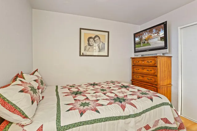 a bedroom with a bed and cupboard