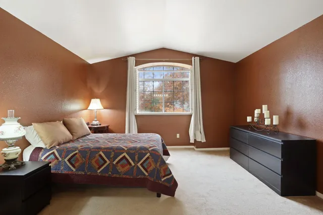 a bedroom with a bed and window