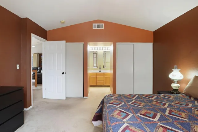 a bedroom with a bed and a lamp