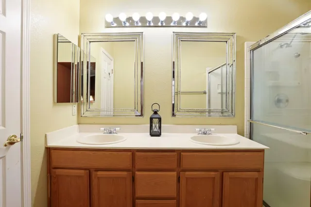 a bathroom with a double vanity sink and a mirror