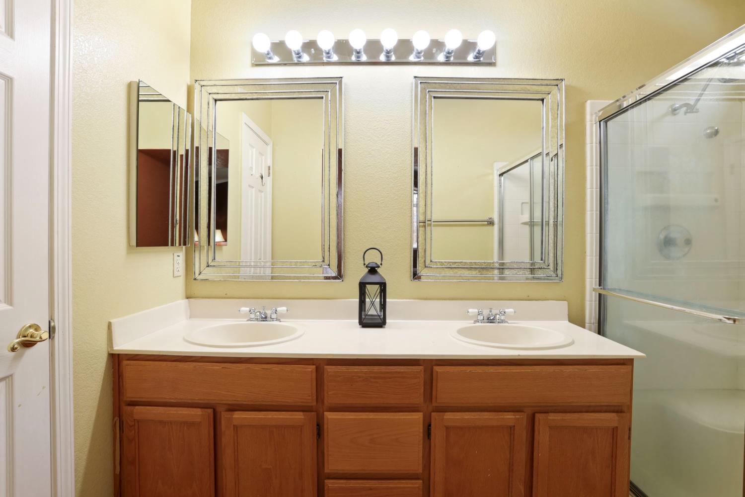 1601 Spring Court Tracy, CA 95376 - Photo 36 of 49 a bathroom with a double vanity sink and a mirror