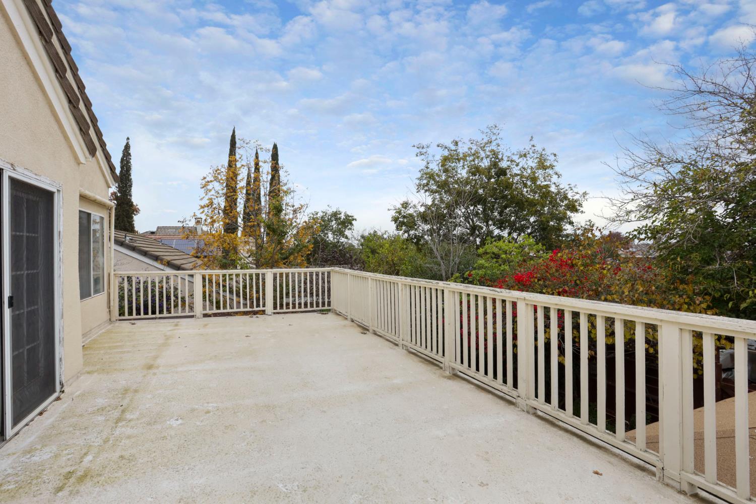 1601 Spring Court Tracy, CA 95376 - Photo 39 of 49 a view of a balcony with wooden fence and trees