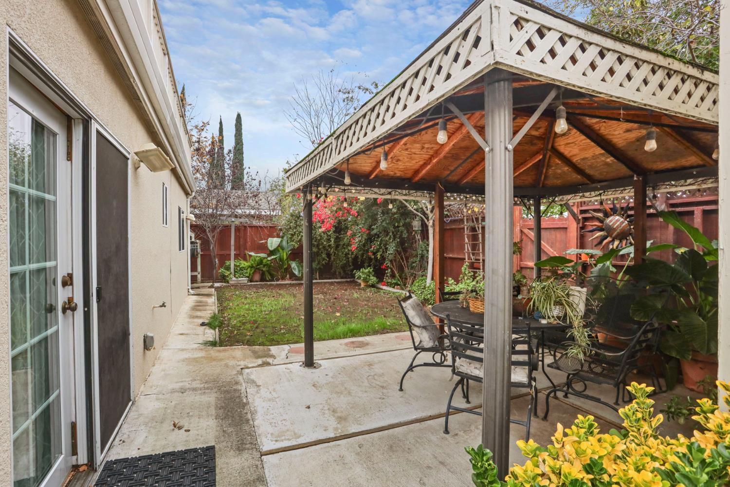 1601 Spring Court Tracy, CA 95376 - Photo 46 of 49 a view of a porch with a table and chairs under an umbrella