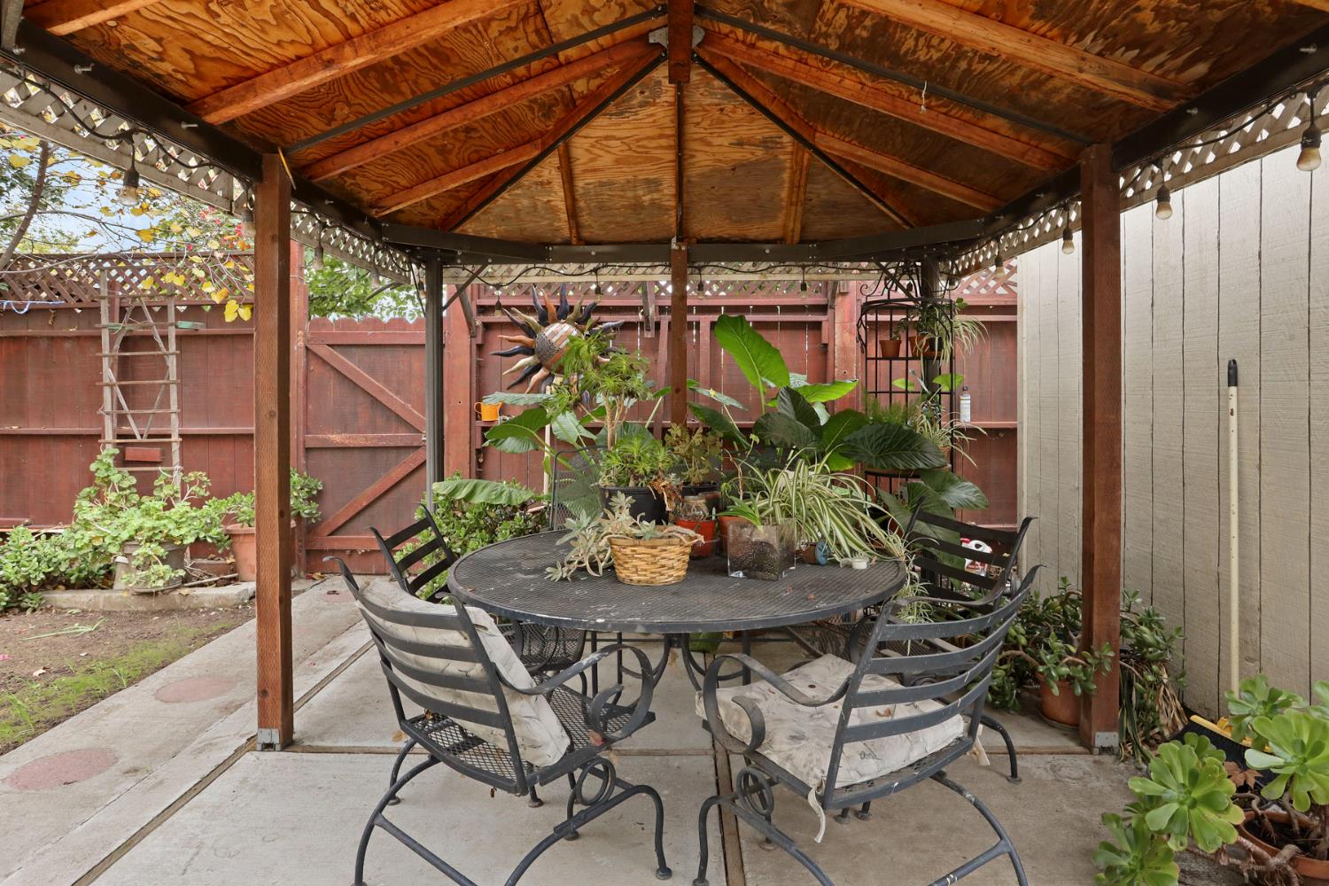 1601 Spring Court Tracy, CA 95376 - Photo 47 of 49 a patio with a patio table and chairs