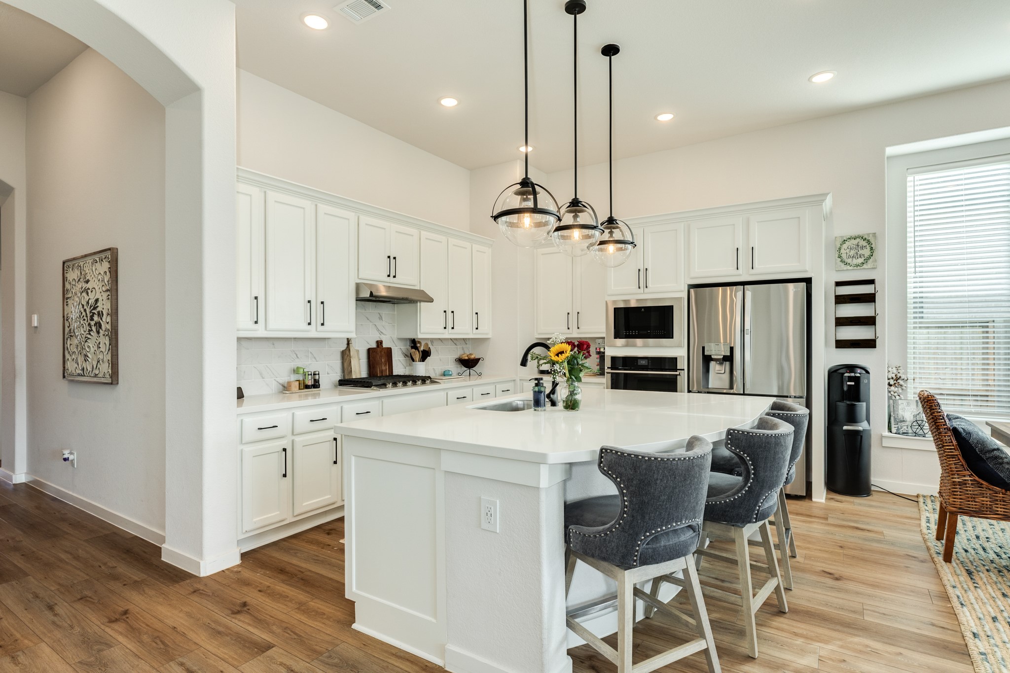 4010 Shackleton Court Iowa Colony, TX 77583 - Photo 7 of 31 Open-concept kitchen featuring OmegaStone countertops and gas cooking.