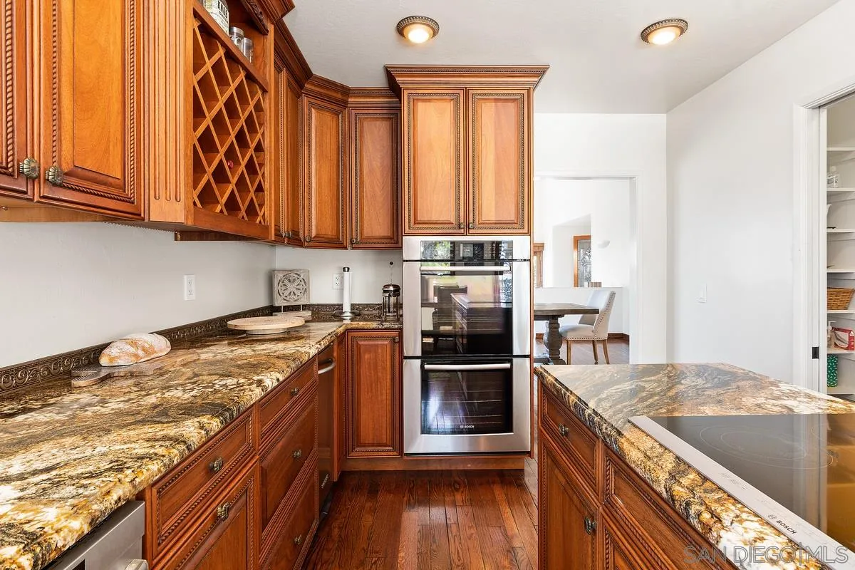 2070 De Mayo Road Del Mar, CA 92014 - Photo 16 of 43 a kitchen with stainless steel appliances granite countertop a stove a sink and a refrigerator