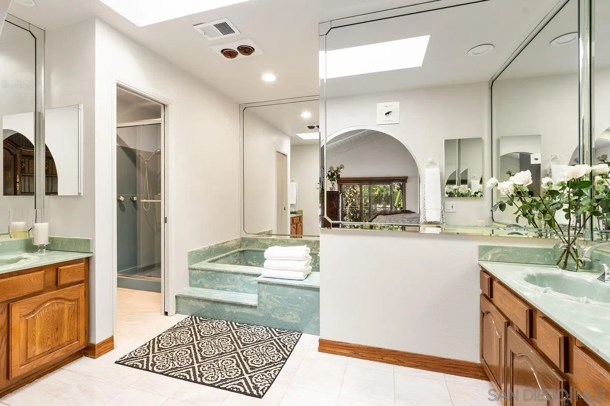 2070 De Mayo Road Del Mar, CA 92014 - Photo 21 of 43 a bathroom with a tub sink and mirror