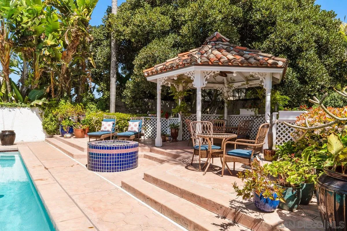 2070 De Mayo Road Del Mar, CA 92014 - Photo 41 of 43 a patio with a table and chairs under an umbrella