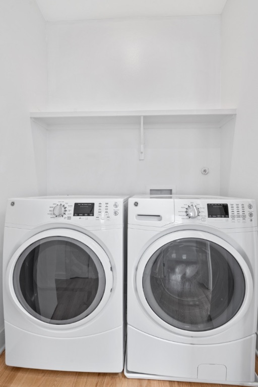 4006 Avenue C, Unit D Austin, TX 78751 - Photo 12 of 14 Laundry room with wood finished floors and washer and clothes dryer