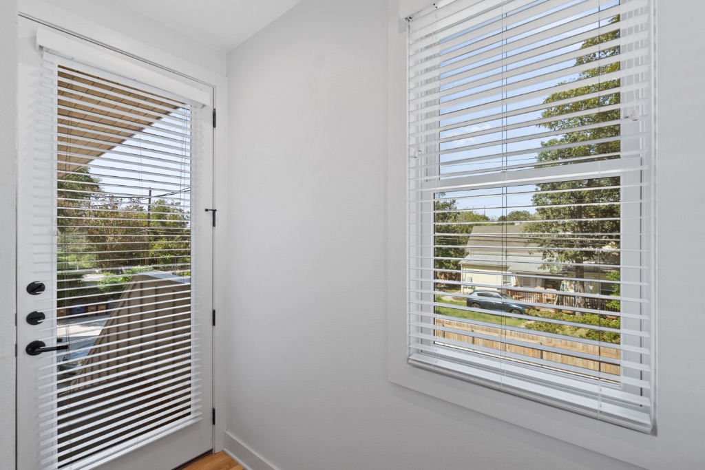 4006 Avenue C, Unit D Austin, TX 78751 - Photo 2 of 14 Doorway with baseboards and wood finished floors