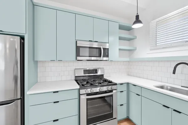 a kitchen with a sink stove and microwave