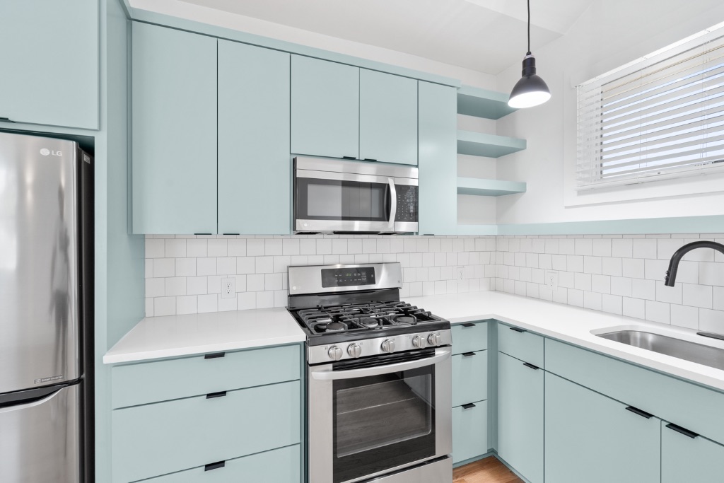 4006 Avenue C, Unit D Austin, TX 78751 - Photo 6 of 14 Kitchen with open shelves, appliances with stainless steel finishes, hanging light fixtures, and backsplash
