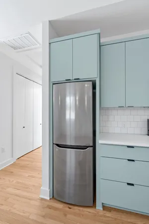 a view of a refrigerator in kitchen and wooden floor