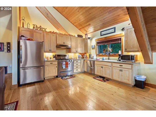 a view of a house with cars parked in front of a house