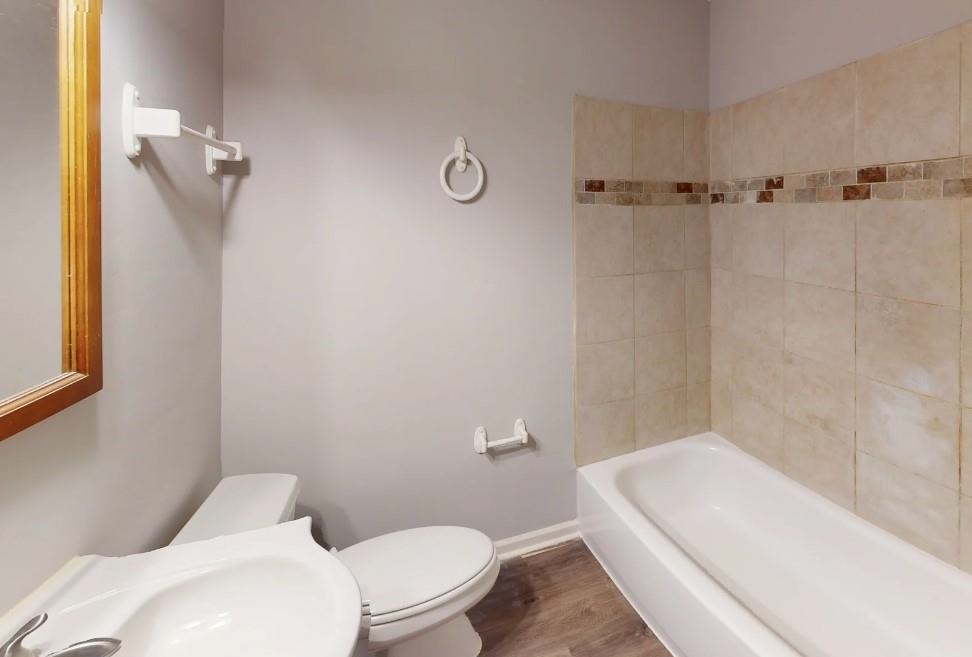 4146 Crain Road Memphis, TN 38128 - Photo 2 of 13 a white toilet sitting next to a bath tub