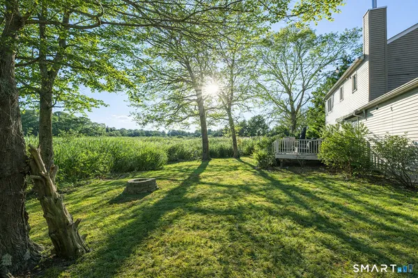 a aerial view of a house with a yard and lake view
