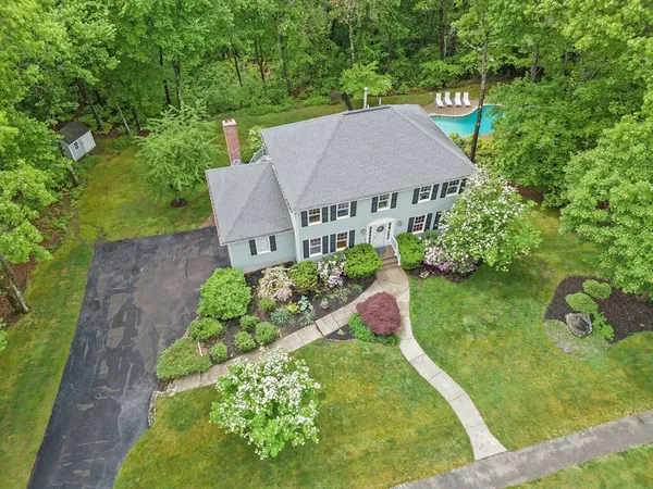 a aerial view of a house with a yard and plants