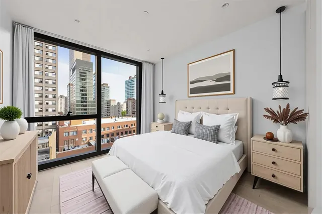 a bedroom with a large bed and a window