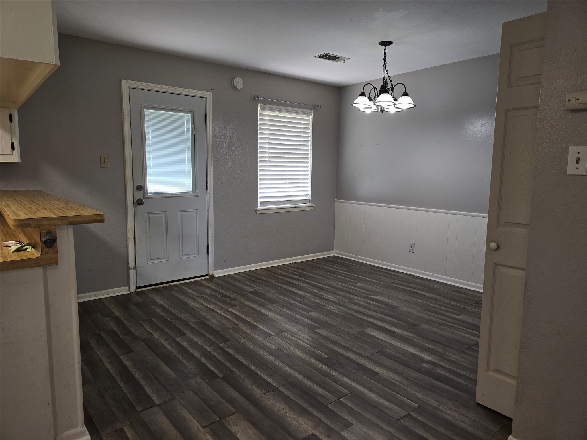17415 Fir Road Alvin, TX 77511 - Photo 8 of 16 wooden floor in an empty room with a window