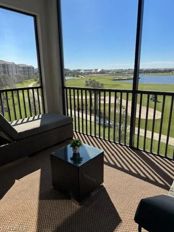 a balcony with wooden floor table and chairs