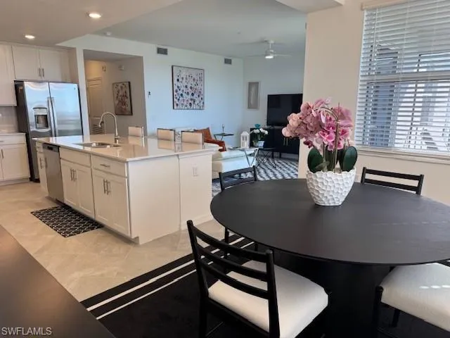 a kitchen with a table chairs and refrigerator