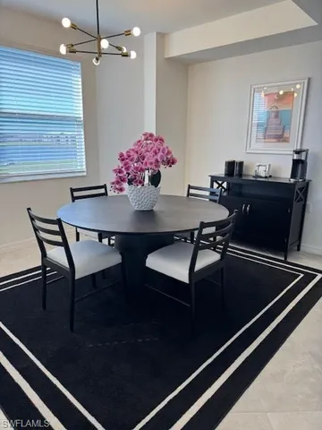 a view of a dining room with furniture and chandelier