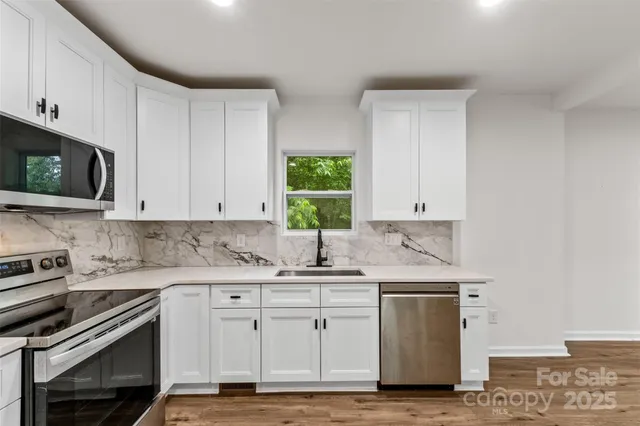 a kitchen with appliances cabinets and a sink