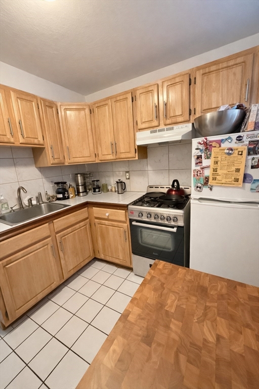 a kitchen with stainless steel appliances a stove sink and cabinets