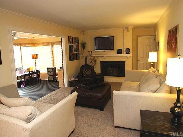 629 Macon Place Raleigh, NC 27609 - Photo 2 of 12 Magnificent living area with masterful fireplace as the focal point, sunroom located to the left and kitchen is right behind you. This is the only room in the house that has carpet all hardwoods, tile or travertine everywhere else.....