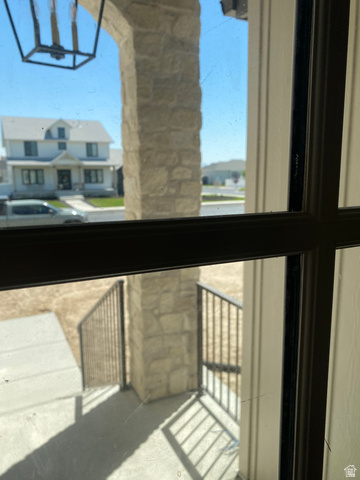 4676 West 75 North, Unit 401 West Point, UT 84015 - Photo 16 of 25 Stone archway entry featuring an exterior lantern light fixture, concrete steps, and dark metal railings