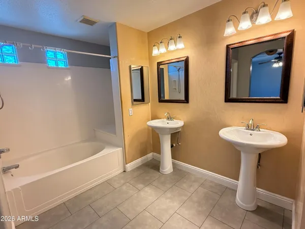 a view of walk in closet and cabinet